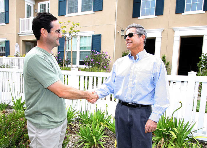 Two men greeting each other with a handshake.