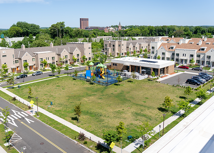 Housing complex aerial shot showing the complex and playground.