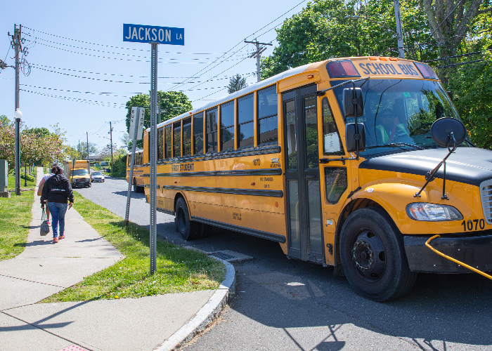 School bus on the corner of a street waiting for school children.