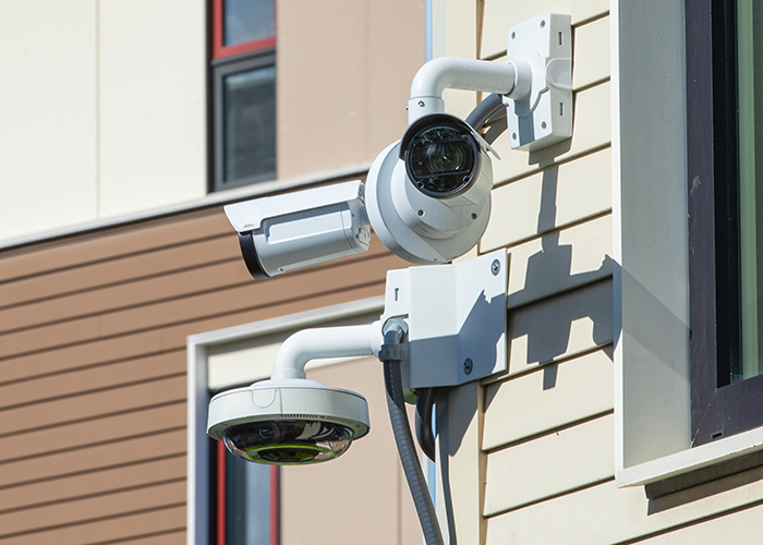 public-ins-camera-img2-700x500px Security cameras posted on the exterior of housing complex.